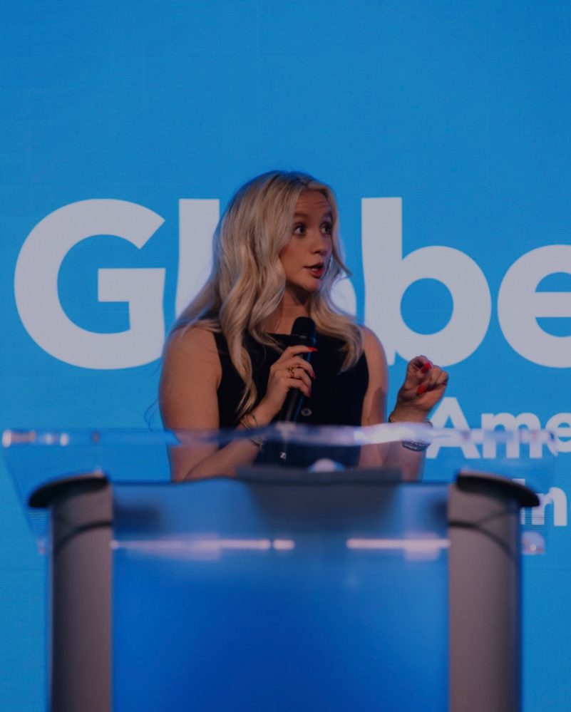 Sarah Glosson with DJ Okungbowa and Arturo Romero on stage